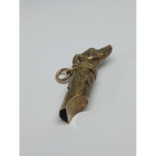 80 - A Victorian yellow metal whistle modelled as a dog's head, length 38mm, unmarked, weight 2.8g.