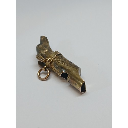 80 - A Victorian yellow metal whistle modelled as a dog's head, length 38mm, unmarked, weight 2.8g.