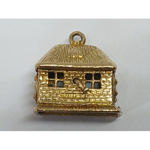 88 - Two hallmarked 9ct gold charms; one modelled as a blacksmith's workshop ant he other a lantern, gros... 