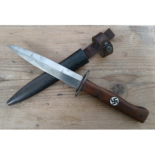 9 - An Imperial/Third Reich German trench knife by Clement & Jung, 14cm steel blade, wooden grip with en... 