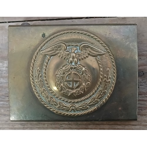 66 - A German Third Reich SA cast belt buckle with applied silver plated badge.