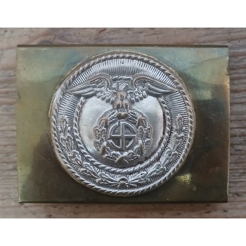 67 - A German Third Reich SA cast belt buckle with applied badge.