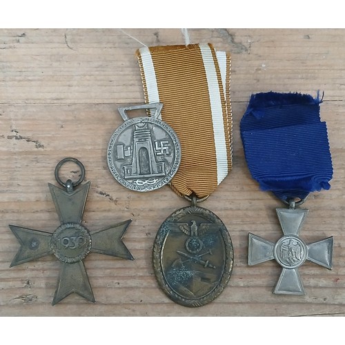 92 - Four German Third Reich WWII medals comprising Westwall, 2nd class War Merit Cross, Long Service Cro... 