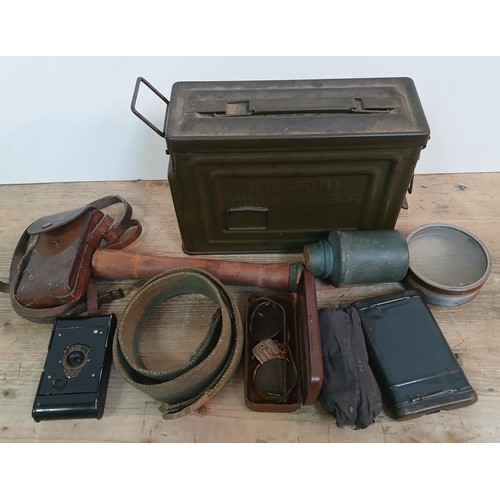 98 - A US Cal .30 M1 ammo tin and contents including a German WWII first aid bandage, a gun cleaning kit,... 