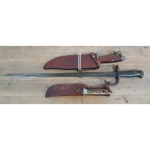 104 - A French bayonet and two hunting knives.