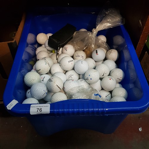 76 - A plastic tub of golf balls