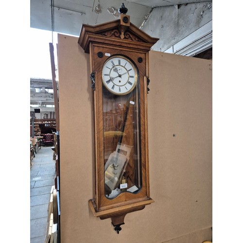 1018 - A walnut cased Vienna wall clock with weight and pendulum.