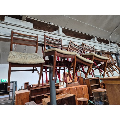 1016 - A set of four mid 20th century teak dining chairs.