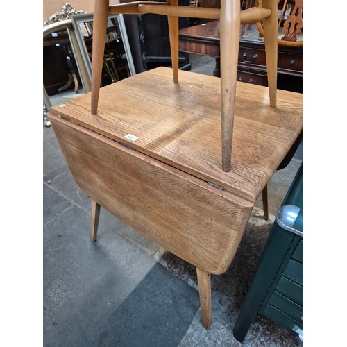 1011 - A 1960s Ercol light elm drop leaf dining table, model 383.