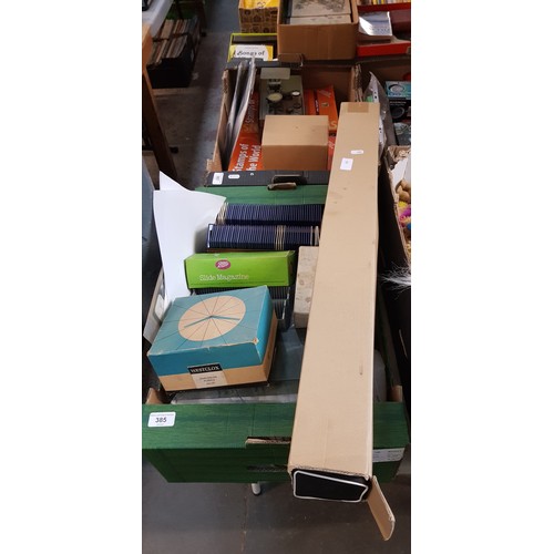 385 - A box of slide, slide magazines, and a projector screen