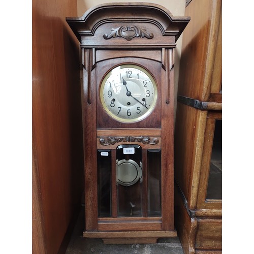 1022 - An early 20th century Westminster chiming wall clock, with pendulum and key.