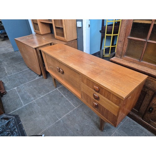 1024 - A teak side board and a teak drop leaf table.