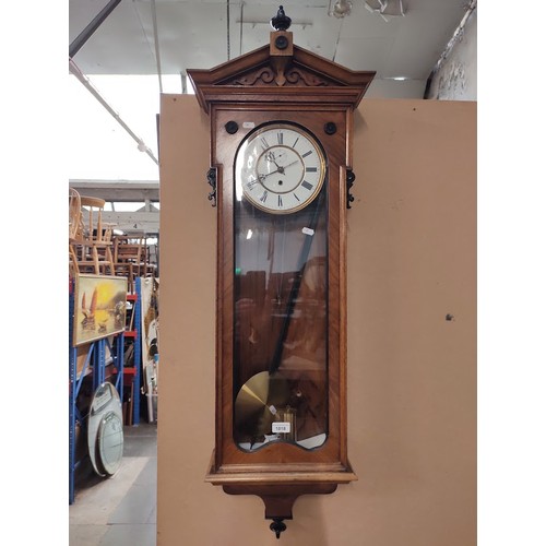 1018 - A walnut cased Vienna wall clock with weight and pendulum.