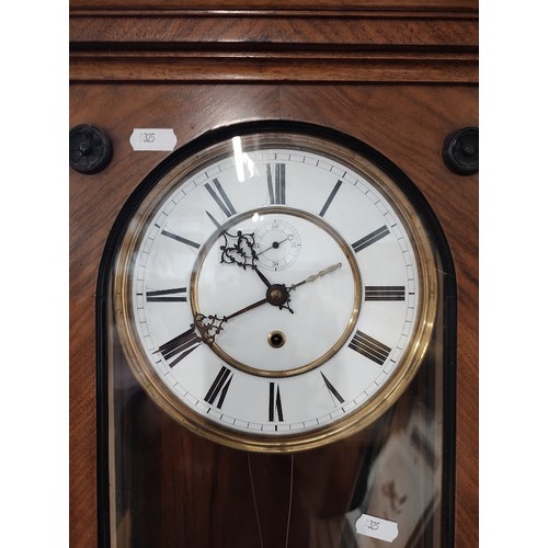 1018 - A walnut cased Vienna wall clock with weight and pendulum.