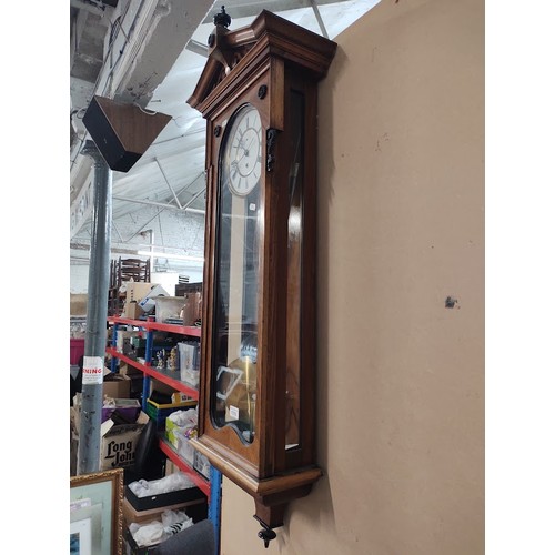 1018 - A walnut cased Vienna wall clock with weight and pendulum.