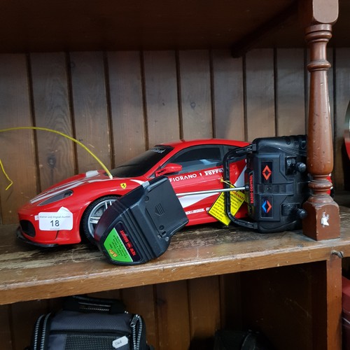 18 - A radio controlled Ferrari F430 together with control and rechargeable battery plug