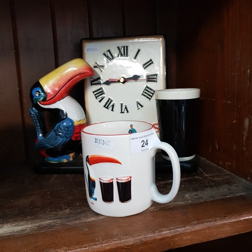 24 - A Guinness ceramic clock together with Guinness mug.