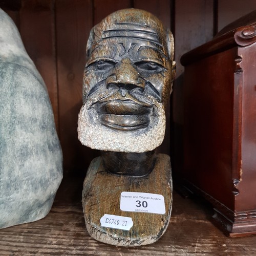 30 - An African carved soapstone bust of a man, 19.5cm.