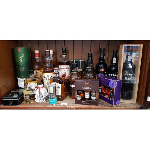 45 - A collection of alcohol to include 4 bottles and 2 half bottles blended whisky, a bottle of Glenfidd... 