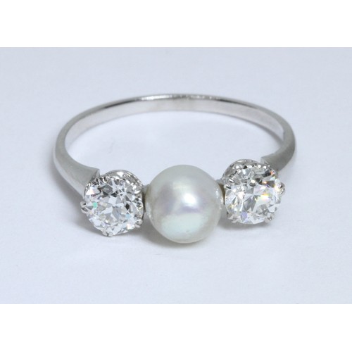 4 - A DIAMOND AND CULTURED PEARL RING, the central slight button shaped pearl measuring approximately 6.... 