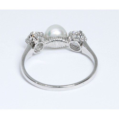 4 - A DIAMOND AND CULTURED PEARL RING, the central slight button shaped pearl measuring approximately 6.... 