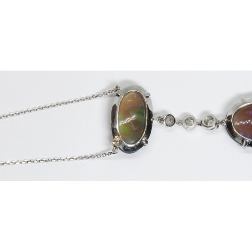 1 - AN OPAL AND DIAMOND PENDANT NECKLACE, early 20th century, two double sided oval opal cabochons four ... 