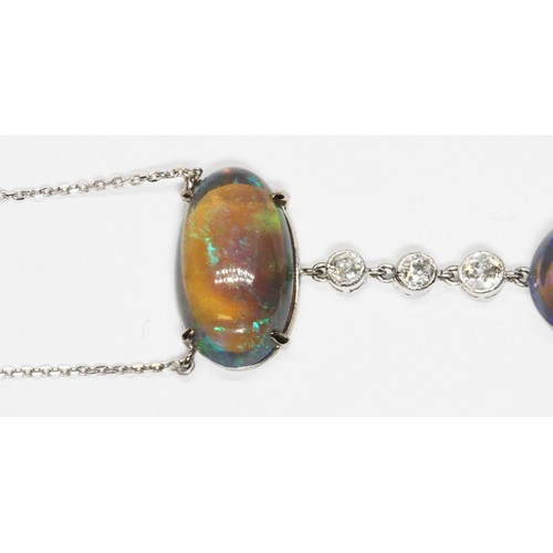 1 - AN OPAL AND DIAMOND PENDANT NECKLACE, early 20th century, two double sided oval opal cabochons four ... 