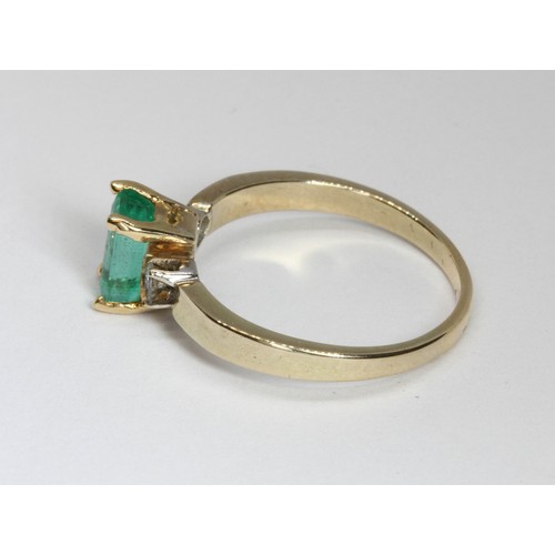 7 - An emerald and diamond ring, the emerald measuring approximately 7.15mm x 4.20mm, depth 3.12mm, set ... 