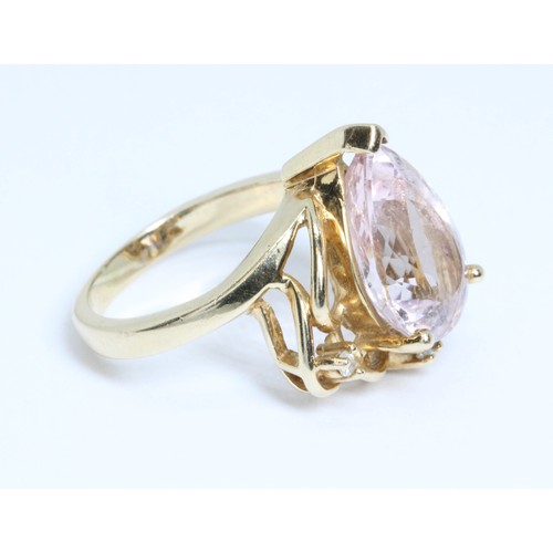 18 - A morganite and diamond cluster ring, the pear shaped pink beryl weighing approximately 4.60ct, mark... 