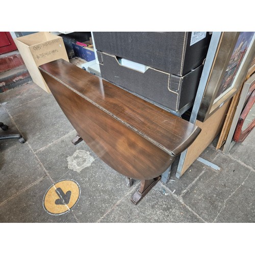 1030 - An Ercol drop leaf table and four Ercol carver chairs.