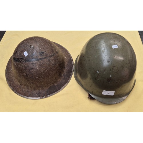 15 - WW11 British steel helmet dated1939 together with an American steel helmet.