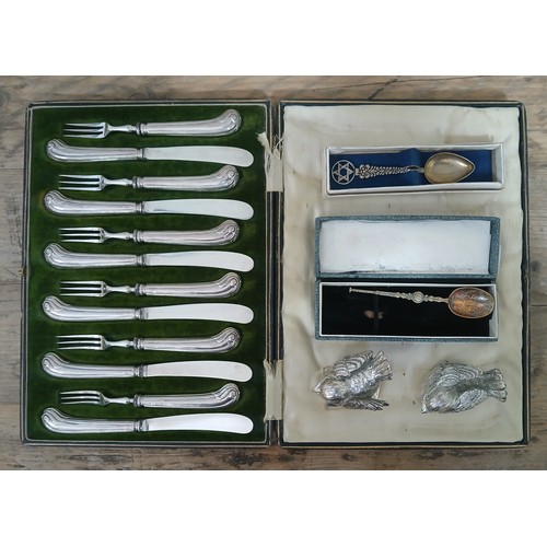 495 - A cased set of twelve hallmarked silver pistol handled knives and forks together with two birds stam... 