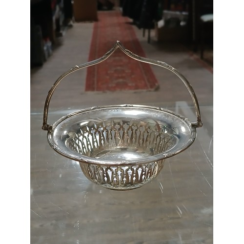 505 - A hallmarked silver basket with swing handle, Walker & Hall, height 12.5cm, weight 5oz 2dwt.