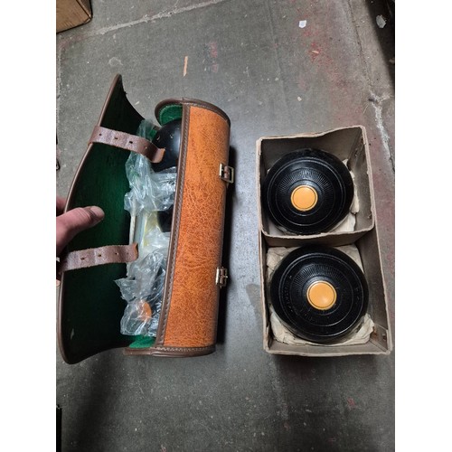 76 - A pair of crown green bowls, and a pair with a jack