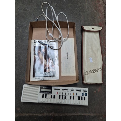 74 - A vintage Casio VL-TONE VL-1 mini electronic musical keyboard from 1982, with case and manual.