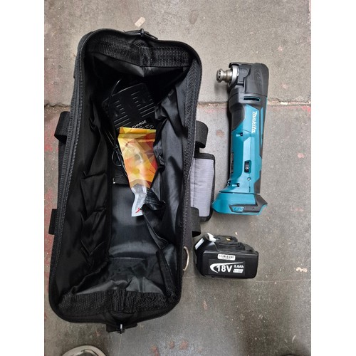 63 - A cordless Makita multi tool, unused, together with battery and charger