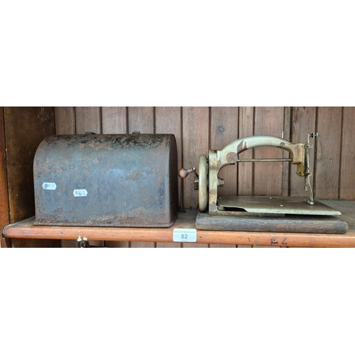 82 - A vintage early 20th century Ideal hand crank sewing machine with metal case.
