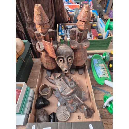 84 - A box of assorted carved tribal items, ethnic, bug bear flask, etc.