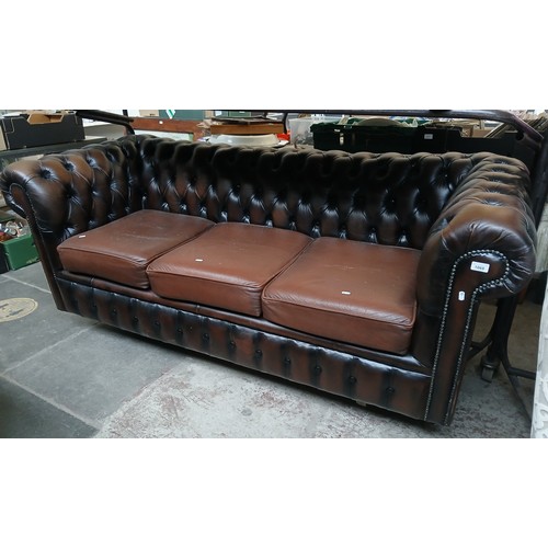 A brown leather 3 seater chesterfield sofa