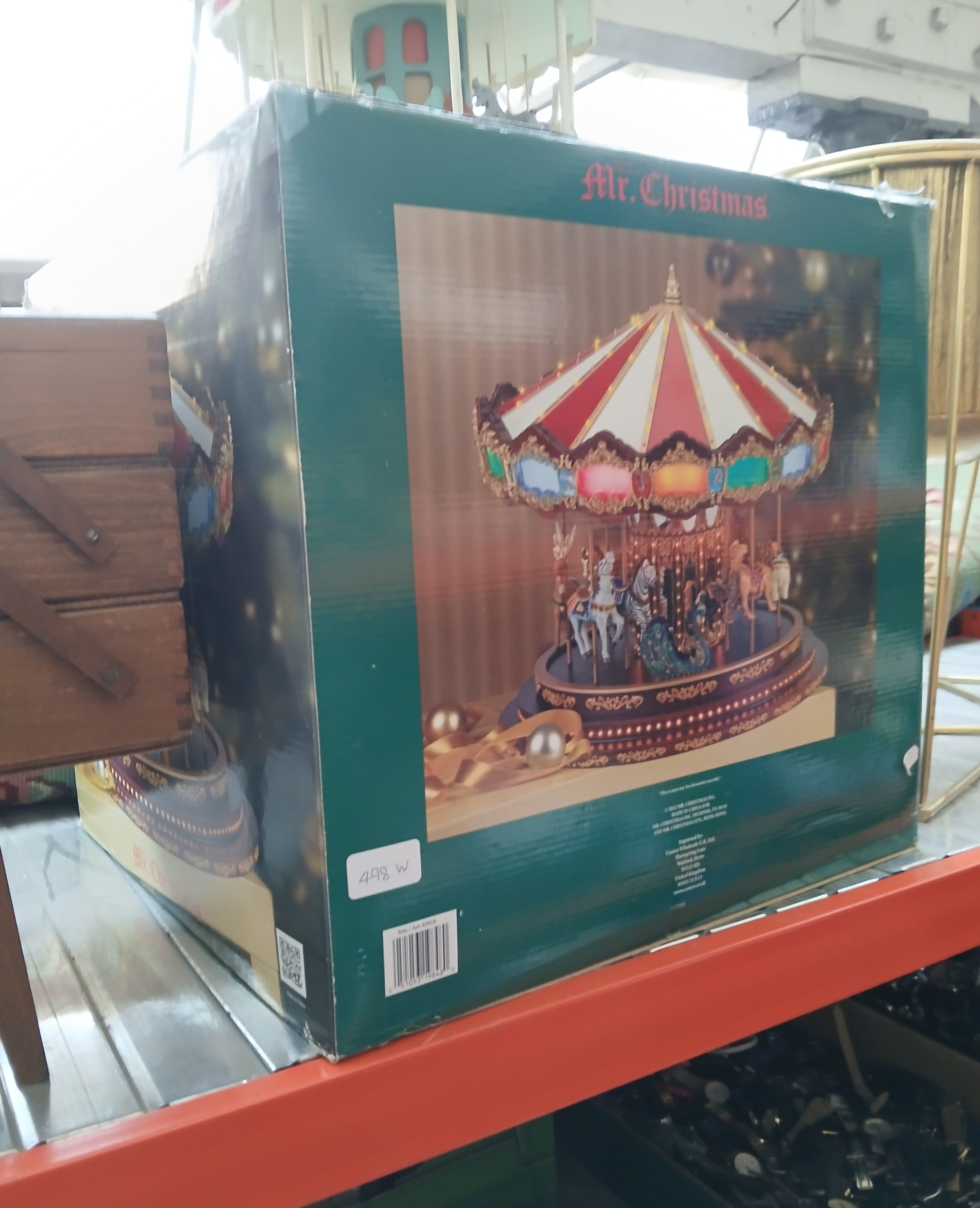 A handmade wooden carousel and an electric marquee grand carousel.