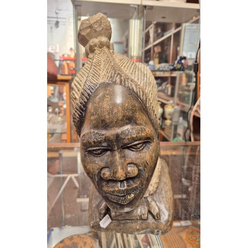 83 - An African carved soapstone bust of a woman.