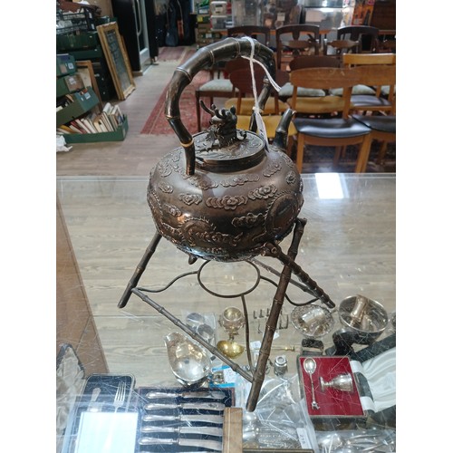 182 - A Chinese silver spirit kettle, decorated with clouds and two dragons, bamboo handle, spout and stan... 