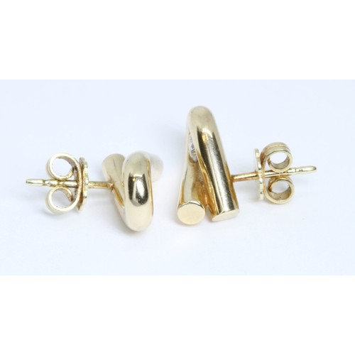 36 - DAVID M ROBINSON, a pair of 14ct gold diamond earrings, each of twist form and set with a round bril... 
