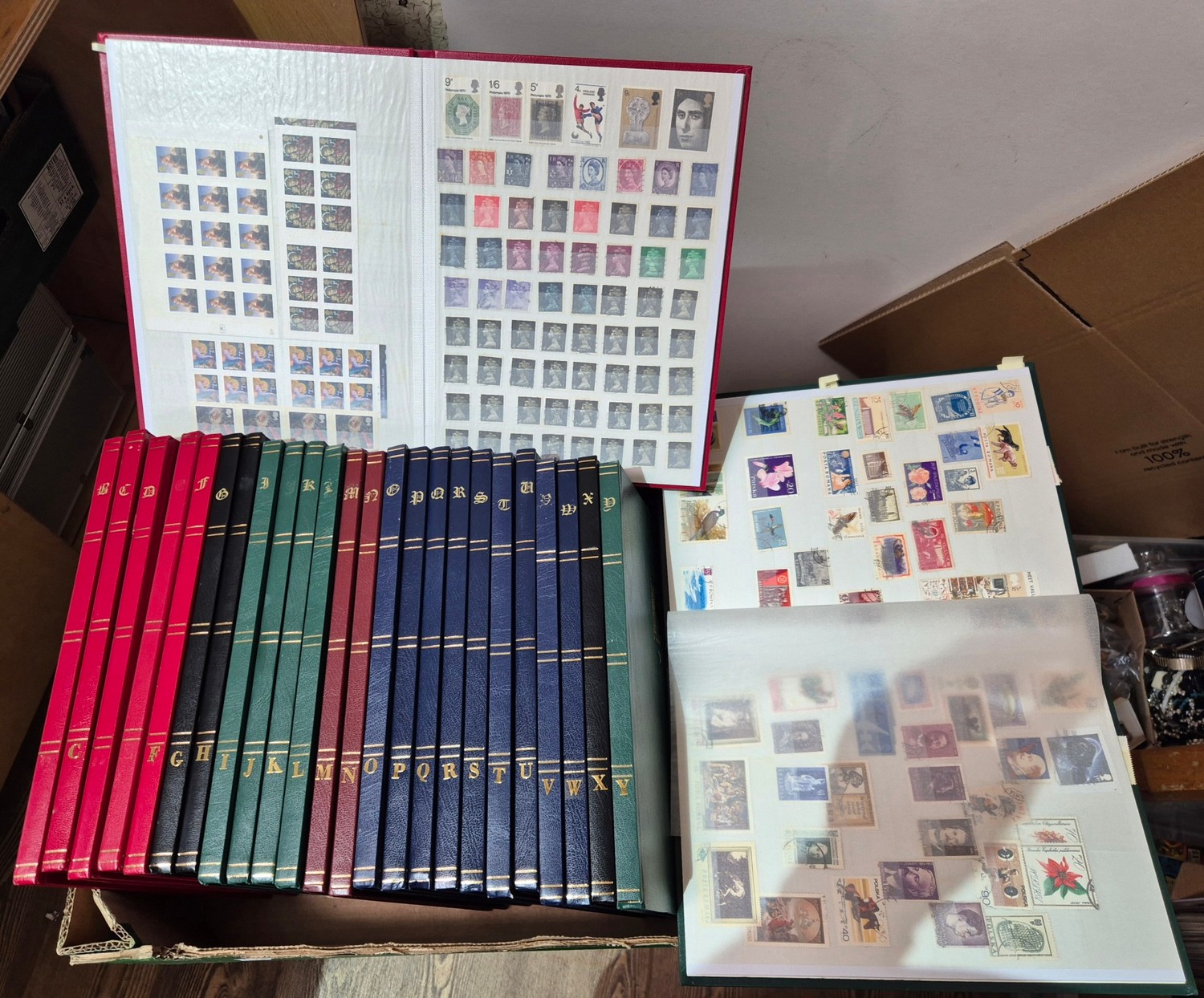 Twenty six assorted stamp albums containing various world stamps.