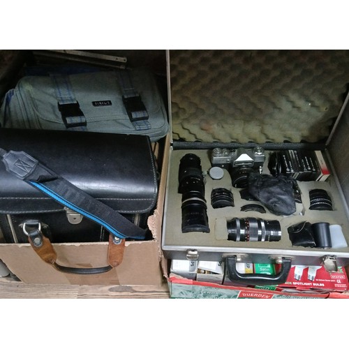 434 - Assorted cameras and accessories comprising a Zenit-E cased with accessories, a Zenit TTL, a Praktic... 