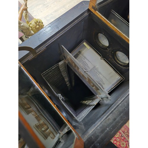 425 - A Victorian walnut floor standing stereoscopic viewer, partially filled with slides, height 121cm.