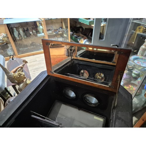 425 - A Victorian walnut floor standing stereoscopic viewer, partially filled with slides, height 121cm.