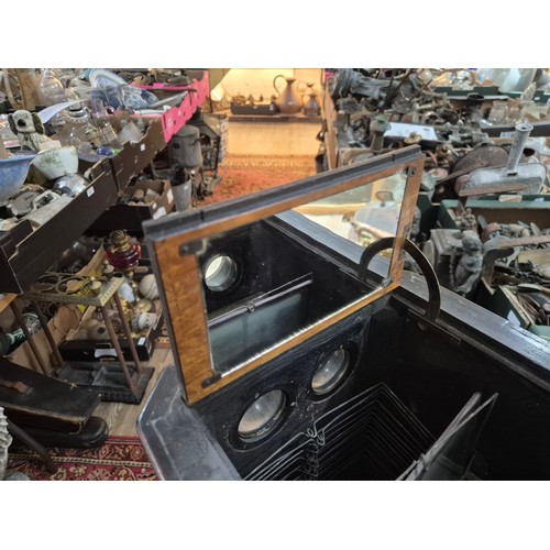 425 - A Victorian walnut floor standing stereoscopic viewer, partially filled with slides, height 121cm.