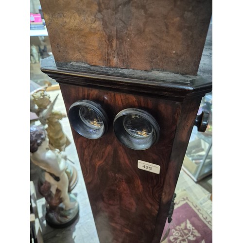 425 - A Victorian walnut floor standing stereoscopic viewer, partially filled with slides, height 121cm.