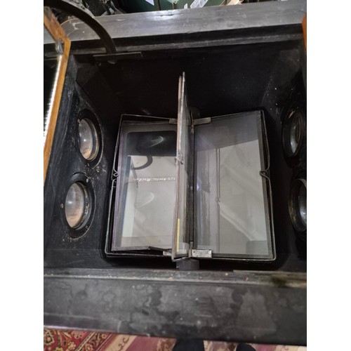 425 - A Victorian walnut floor standing stereoscopic viewer, partially filled with slides, height 121cm.